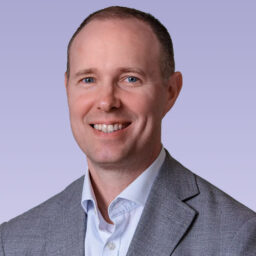 Kenneth Harrison in a dark grey blazer and white button up